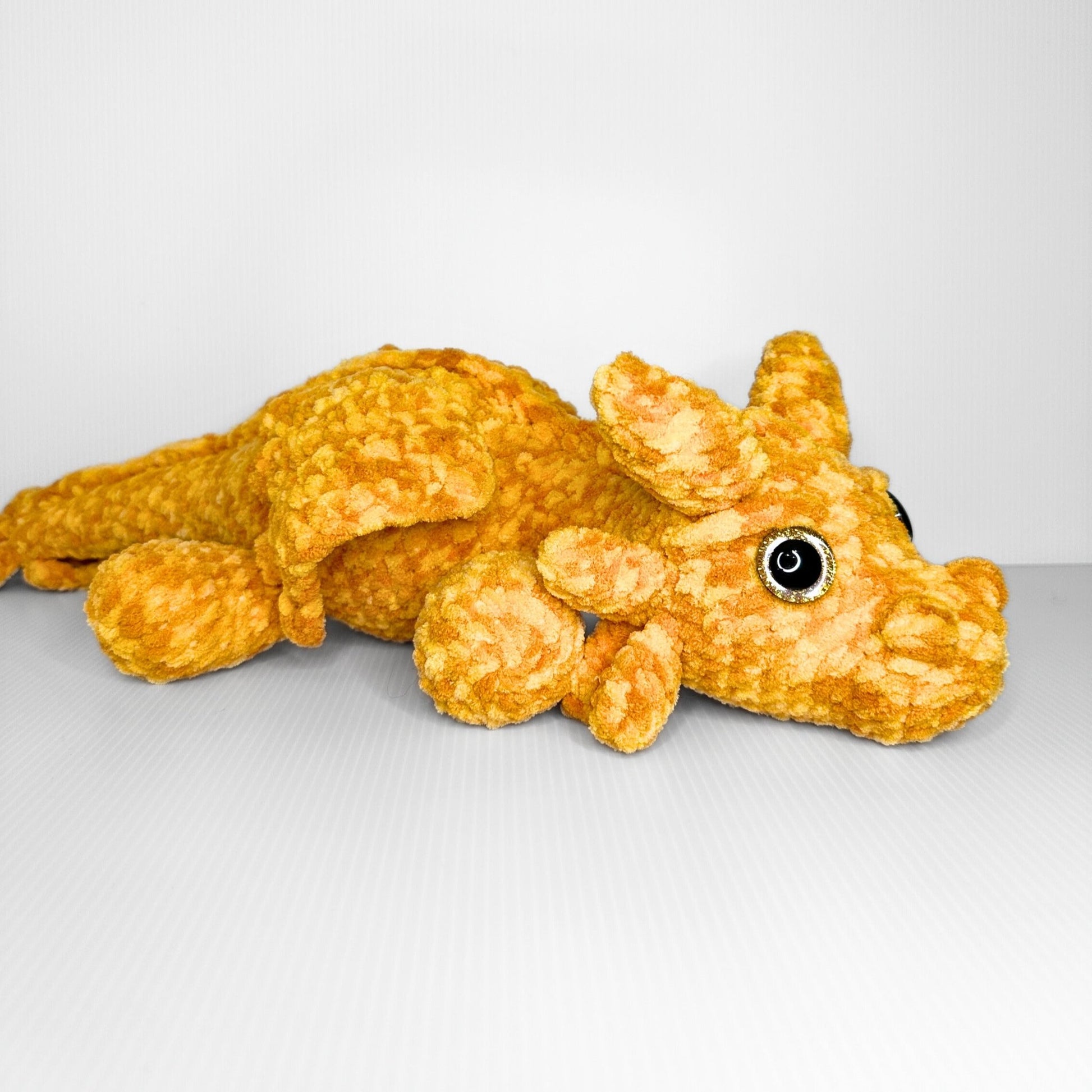 Handmade Golden Feathertail Dragon Crochet Plush — Large Laying Fantasy Dragon in Warm Gold Velvet Yarn - pursuitofcraftyness