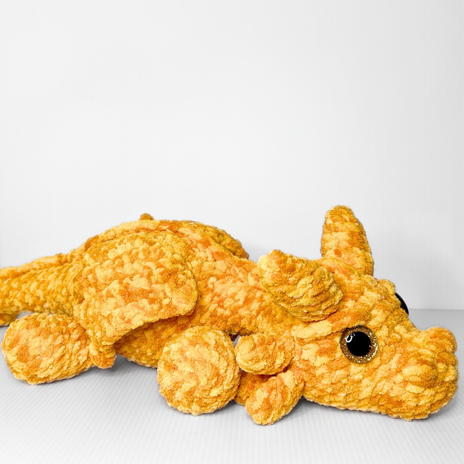 Handmade Golden Feathertail Dragon Crochet Plush — Large Laying Fantasy Dragon in Warm Gold Velvet Yarn - pursuitofcraftyness