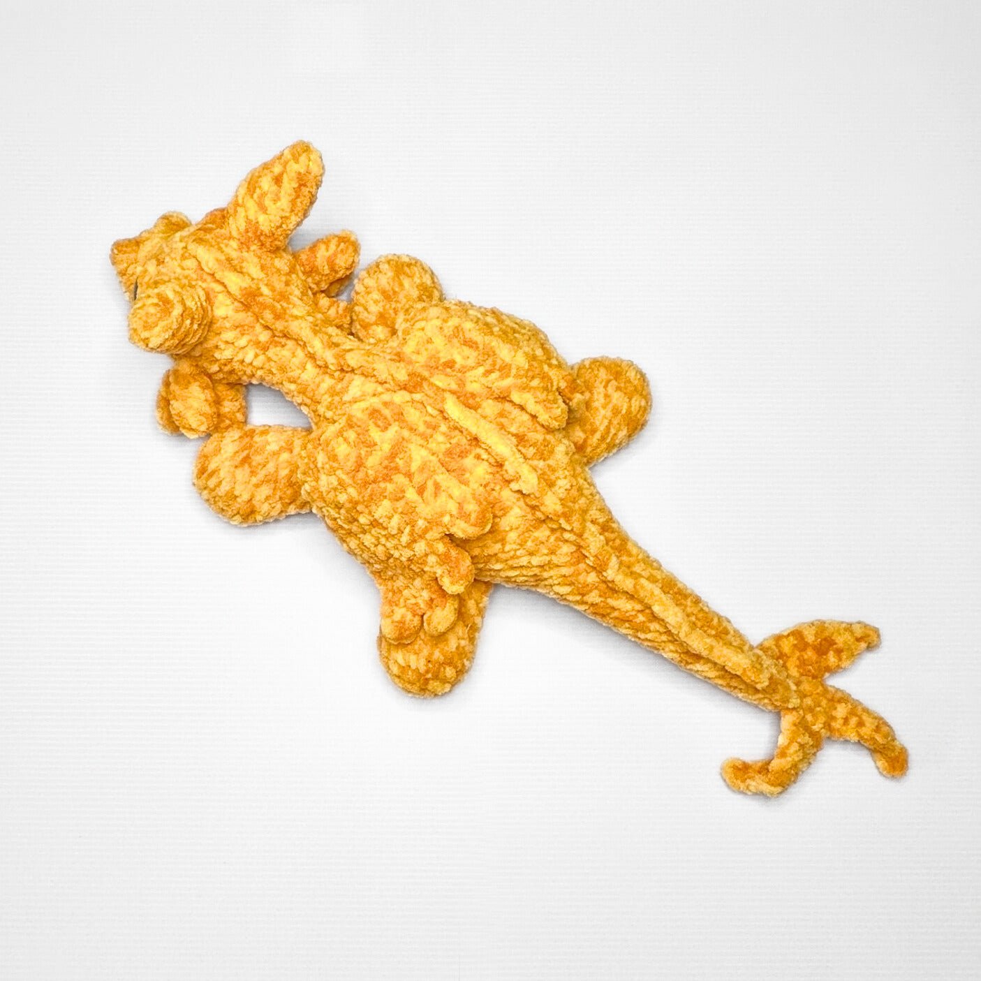 Handmade Golden Feathertail Dragon Crochet Plush — Large Laying Fantasy Dragon in Warm Gold Velvet Yarn - pursuitofcraftyness