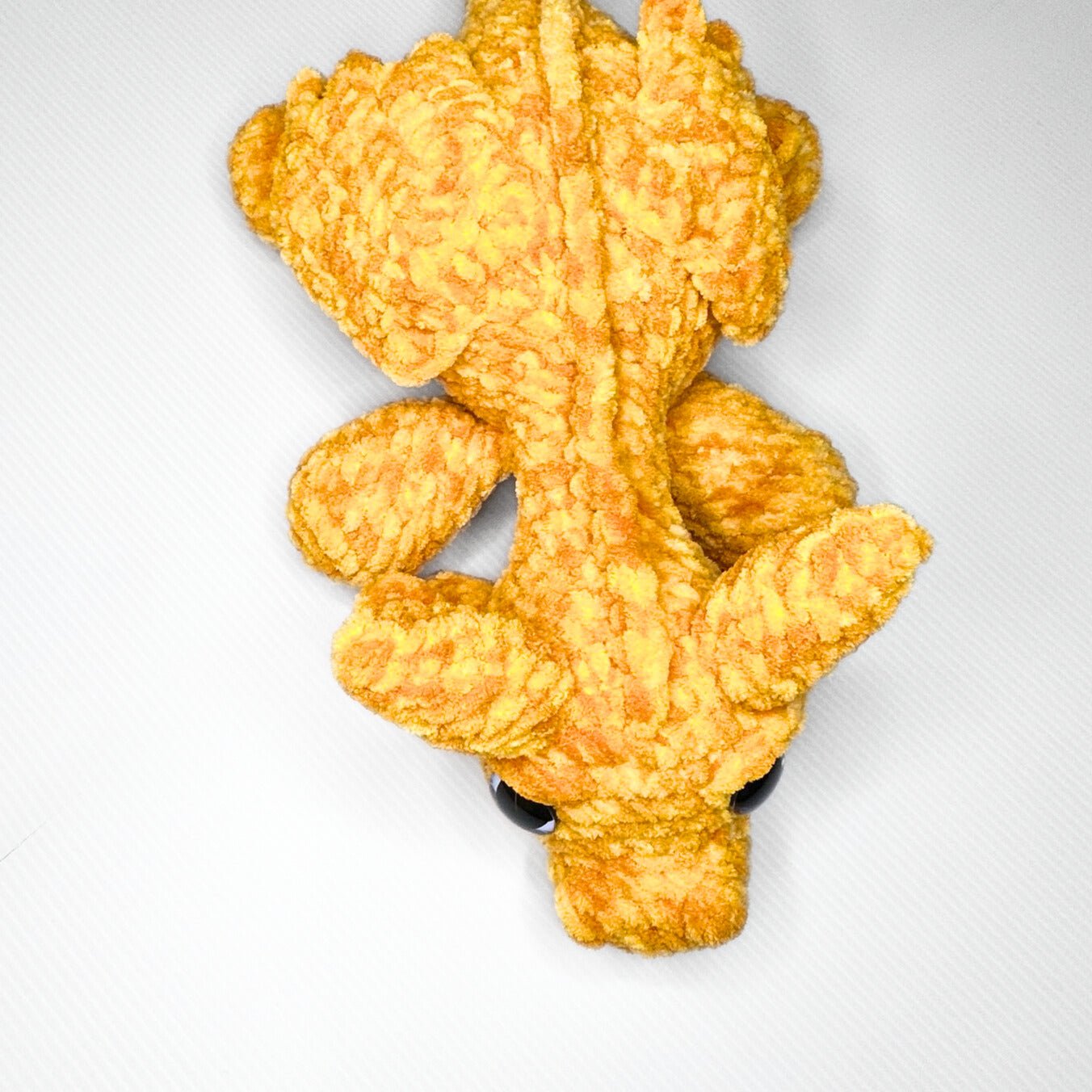 Handmade Golden Feathertail Dragon Crochet Plush — Large Laying Fantasy Dragon in Warm Gold Velvet Yarn - pursuitofcraftyness